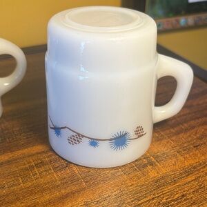 Elegant White Mug with Blue and Brown Pinecone Motif